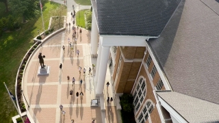 Aerial view of students near campus library with large sidewalks and statue of Abraham Lincoln